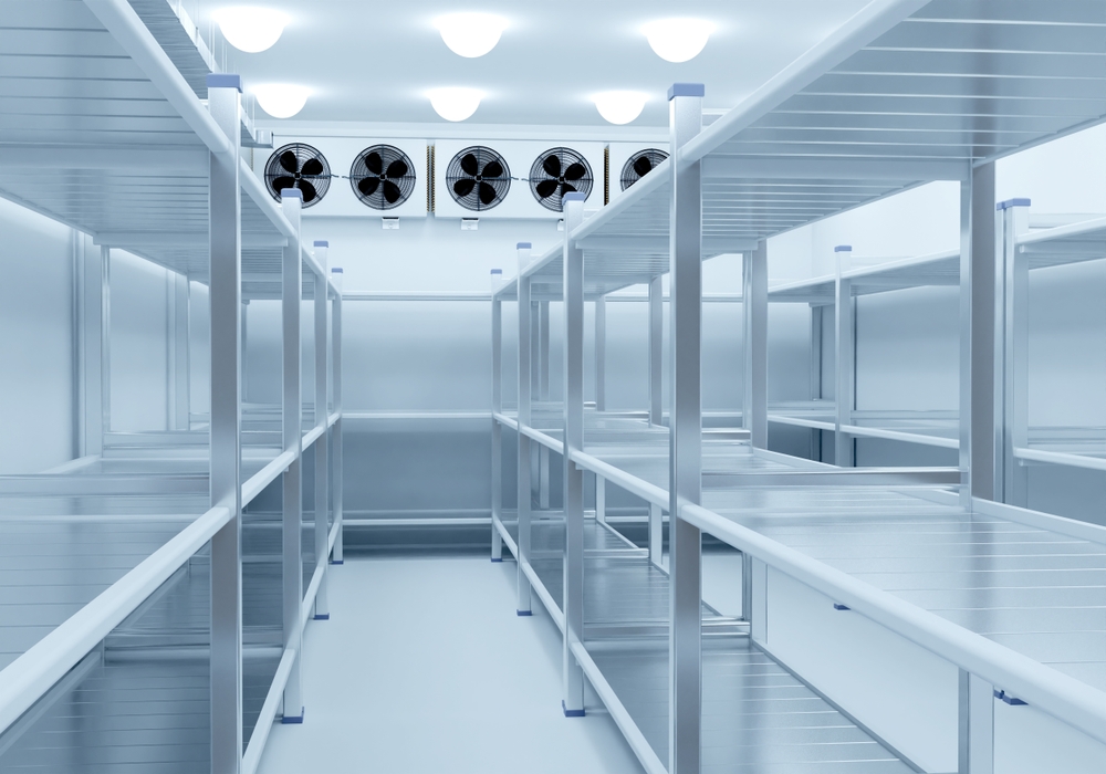 An,empty,industrial,cold,storage,room,with,metal,shelves,and